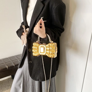 Chic gold bow-shaped chain bag for women with metallic finish and top handle