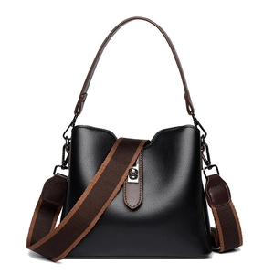 Black leather bucket bag with litchi texture featuring a wide woven shoulder strap
