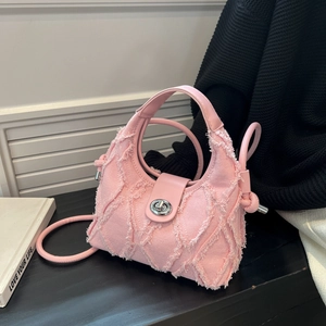 Pink denim crossbody hobo bag with frayed edges and silver metal lock closure