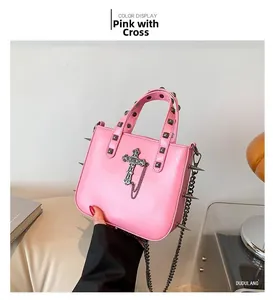 Detail of pink punk handbag with metallic cross pendant and silver square rivets