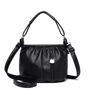 Women's black faux leather handbag with pleated details and heart-shaped metal zipper pull