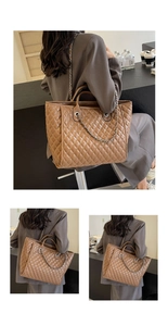 Detail of brown quilted leather tote bag featuring chain strap and spacious interior