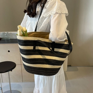 Large capacity striped straw tote bag with black leather shoulder straps and fabric lining