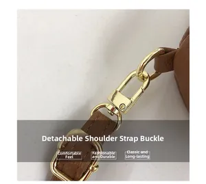 Detail of brown lychee grain leather strap with polished gold lobster clasp hardware