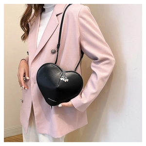 Détail du sac à bandoulière en forme de cœur avec zips trèfle et lettrage fashion
