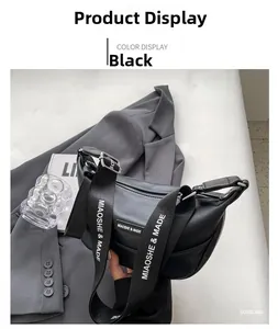 Detailed macro view of black PU leather dumpling bag with textured finish and branded strap