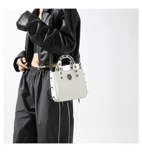 Close-up of white gothic bag featuring a 3D skull, metal spikes and rivet handle detail