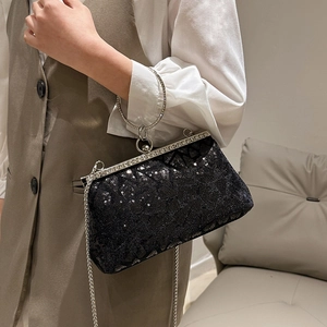 Sparkling black sequin evening handbag with a rhinestone round handle and silver chain strap