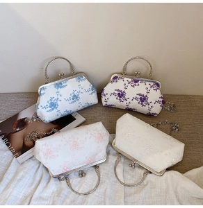 Detailed view of floral embroidery patterns and vintage metal clasps on elegant evening bags