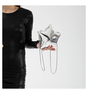 Close-up of a silver star-shaped acrylic evening bag with a sleek metallic chain strap