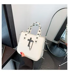 Gothic white leather bag with metal cross, chain details and silver studs on strap