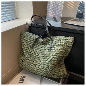 Close-up of green woven straw tote bag texture with brown leather straps in cozy setting