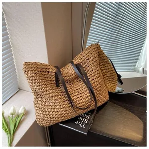 Close-up of woven straw tote bag texture with premium brown faux leather handles