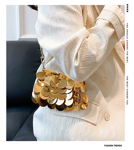 Detail view of mini gold sequin evening bag with metallic chain and scale texture