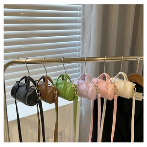 Close-up of stylish cylinder crossbody bags in six colors with litchi texture and logo