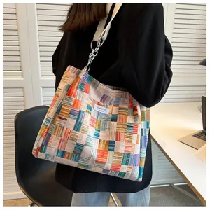 Macro detail of niche design label on colorful patchwork tote bag with wide strap