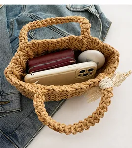 Top view of hand-woven beige tote bag with white bow showing spacious interior capacity