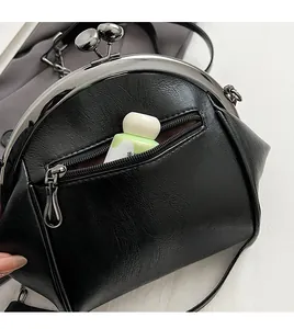 Close-up of the black shell-shaped bag featuring a secure back zipper anti-theft pocket