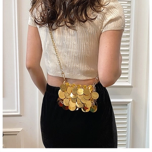 Detail of mini sequin chain bag in bright gold, showing metallic texture and crossbody style