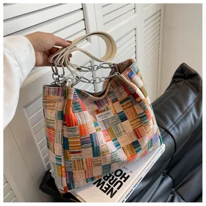 Detailed macro view of colorful geometric woven fabric and silver metal chain strap