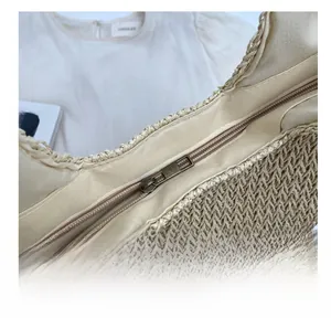Close-up of smooth metal zipper and two-tone woven texture on this large tote bag