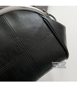 Macro detail of high-quality black textured leather bag with metallic kiss-lock clasp