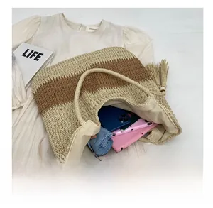Interior view showing the large capacity of the striped woven straw tote bag