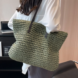 Large moss green woven straw tote bag with brown leather straps for beach and commuting