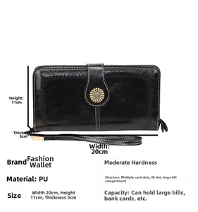 Detailed view of black oil wax leather wallet with daisy buckle and white stitching details