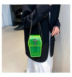 Detail shot of neon green PVC coffin bag with silver rivets and gothic cross pendant
