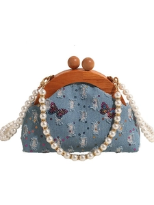 Denim shoulder bag with butterfly embroidery, wooden frame handle and pearl chain straps