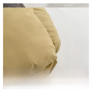 Detailed macro view of khaki quilted fabric and a vintage monogram pattern strap