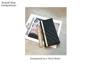 Quilted black long wallet with gold metal trim shown next to a 15cm ruler for size
