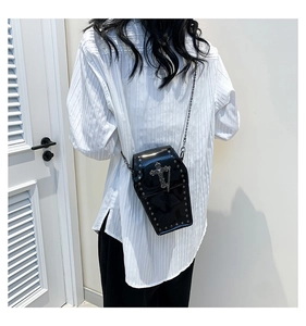Gothic coffin-shaped crossbody bag in black patent leather with silver studs and chains