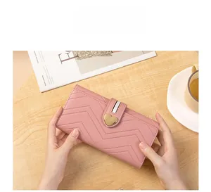 Pink long wallet with V-shaped quilting and a gold heart-shaped metal buckle detail