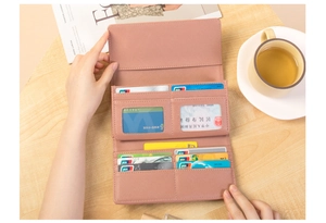 Detail view of pink leather long wallet with multi-slot card holder and ID window