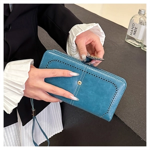 Detail of blue vintage oil wax leather wallet with hollow cutout and contrast stitching