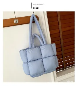 Detail of the light blue quilted puffer tote bag with thick woven padded design