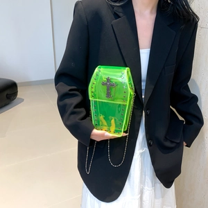 Neon green coffin-shaped mini crossbody bag with gothic rivets and metal cross detail