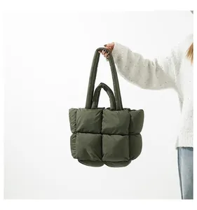 Close-up of army green quilted puffer tote bag with thick padded top handle for women