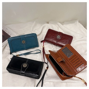 Detail of multi-slot interior and vintage button clasp on oil wax leather wallets