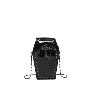 Gothic coffin-shaped crossbody bag in black patent leather with metal rivets and cross