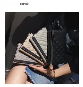 Detailed group shot of quilted long wallets in grey, pink, and black with metal trim