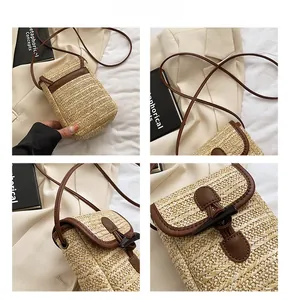 Detail showing woven straw texture, dark brown leather trim and retro horn buckle closure