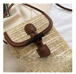 Detail shot of the woven straw texture and classic dark brown horn buckle closure