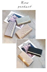 Detail of elegant quilted leather long wallets with golden metal trim in multiple colors