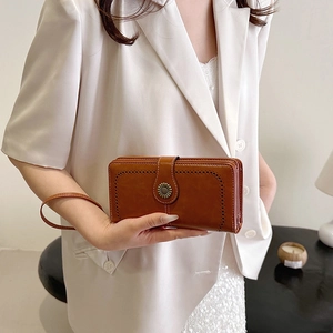 Retro wax leather long wallet for women with floral buckle and wrist strap detail