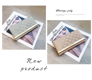 Detailed view of quilted long wallets in sage green and apricot with metal trim decorations