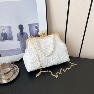 Elegant white satin evening bag featuring floral embroidery and pearl handle details