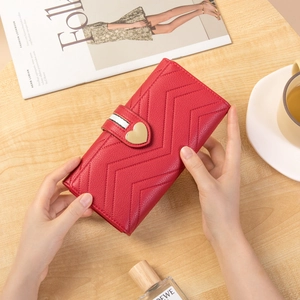 Elegant red long wallet for women with V-shaped quilting and golden heart buckle
